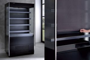 A black refrigerated display case with glass shelves and a digital control panel is shown on the left. On the right, a hand pulls down a transparent cover over the shelves.