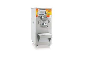A commercial gelato or ice cream making machine with a stainless steel exterior, digital controls, and a dispensing spout, standing on four small wheels against a white background.