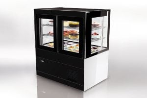 A black and white commercial refrigerated display case with glass doors and shelves, showcasing various cakes and desserts inside.