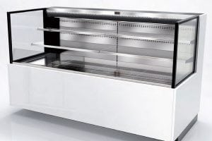 A commercial refrigerated display case with glass front and sides, empty metal shelves, and a white lower base, designed for showcasing food items in a retail or restaurant setting.