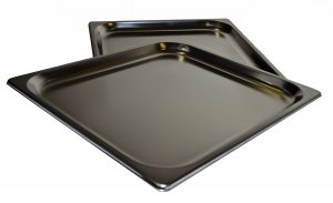 Two shiny, rectangular metal baking trays are stacked slightly askew on a white background.