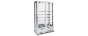 A tall, glass display refrigerator with multiple shelves and sliding doors, designed for showcasing food or beverages in a commercial setting. The unit has a metallic frame and a vent at the bottom.