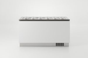 A modern, minimalist white rectangular chest with a decorative cutout pattern on its flat top and a small ventilation grille near the base, set against a plain white background.