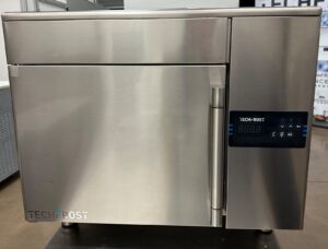 A stainless steel Techfrost commercial blast chiller with a digital control panel and handle on the right, sitting on a countertop in an industrial kitchen setting.